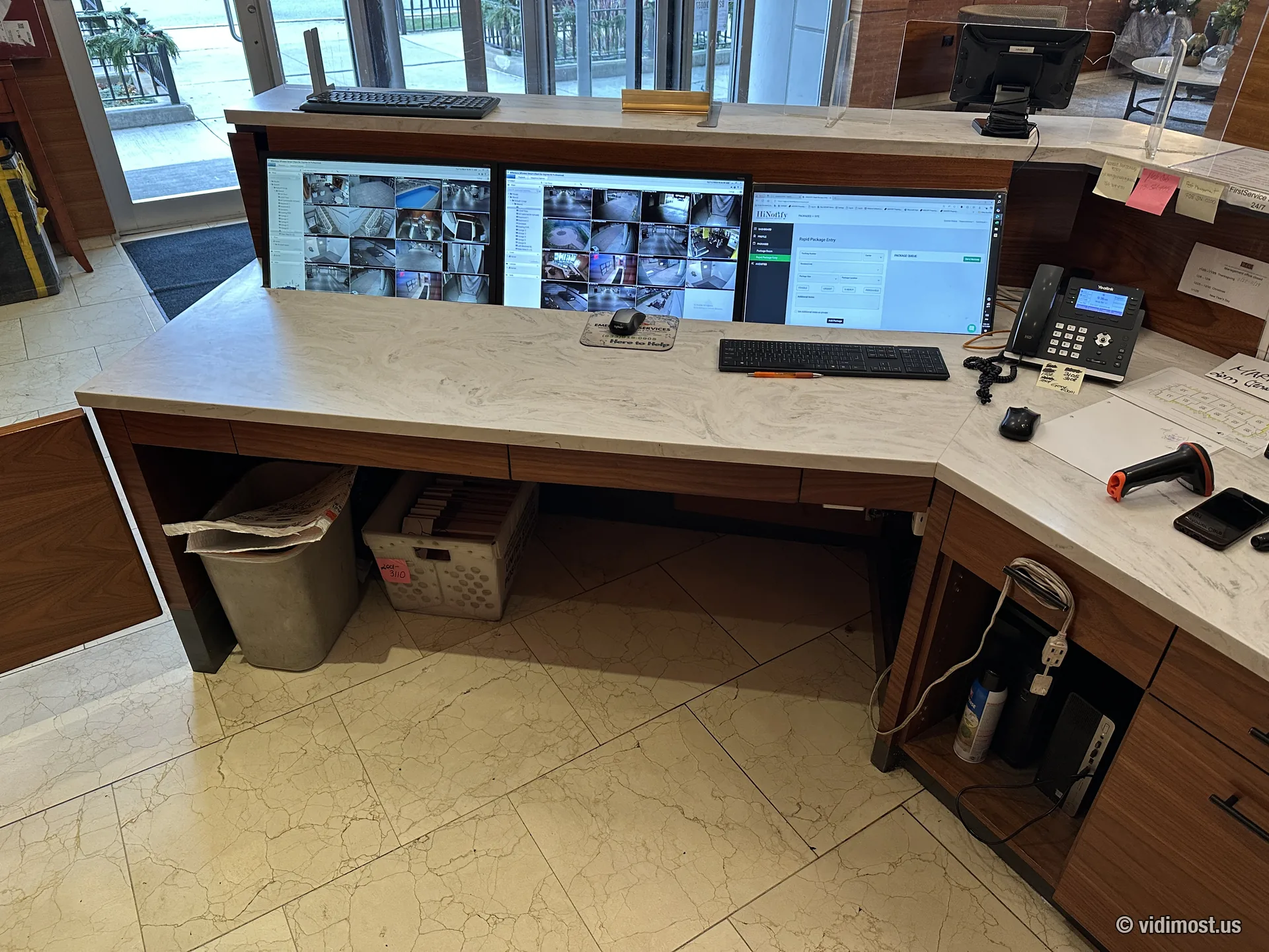 Front desk monitors showing dozens of security camera views in a Chicago condo building