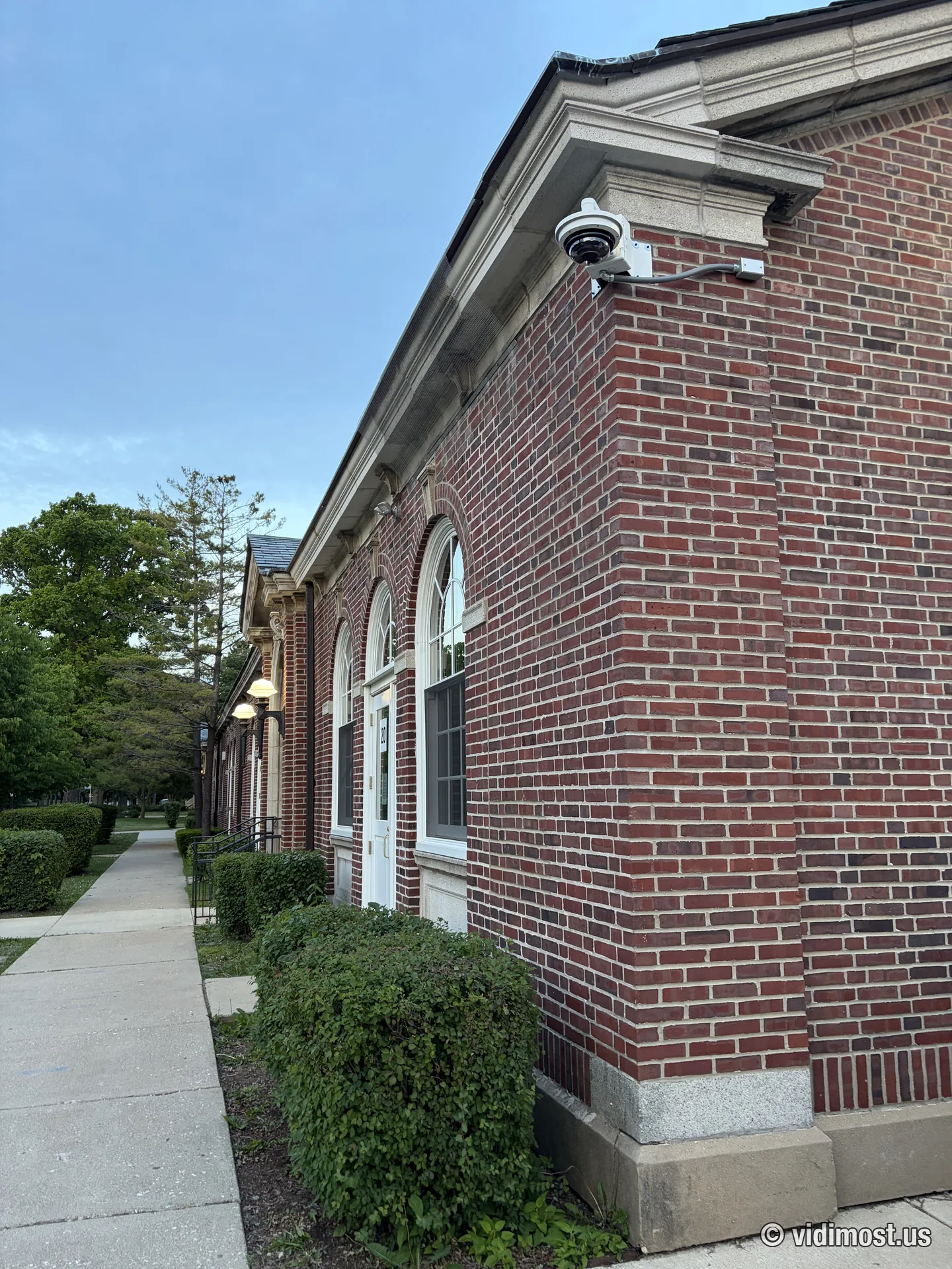 Dome security camera installed at the entrance corner of a brick building in Chicago